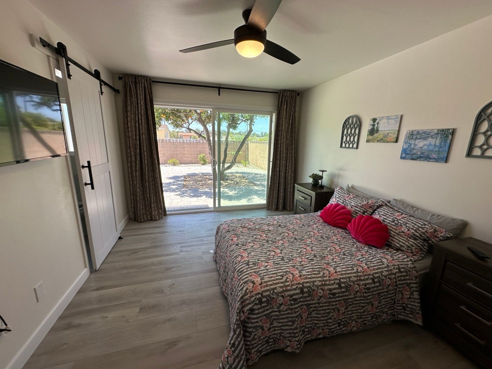 Spacious semi-private bedroom with barn door and sliding door to the backyard
