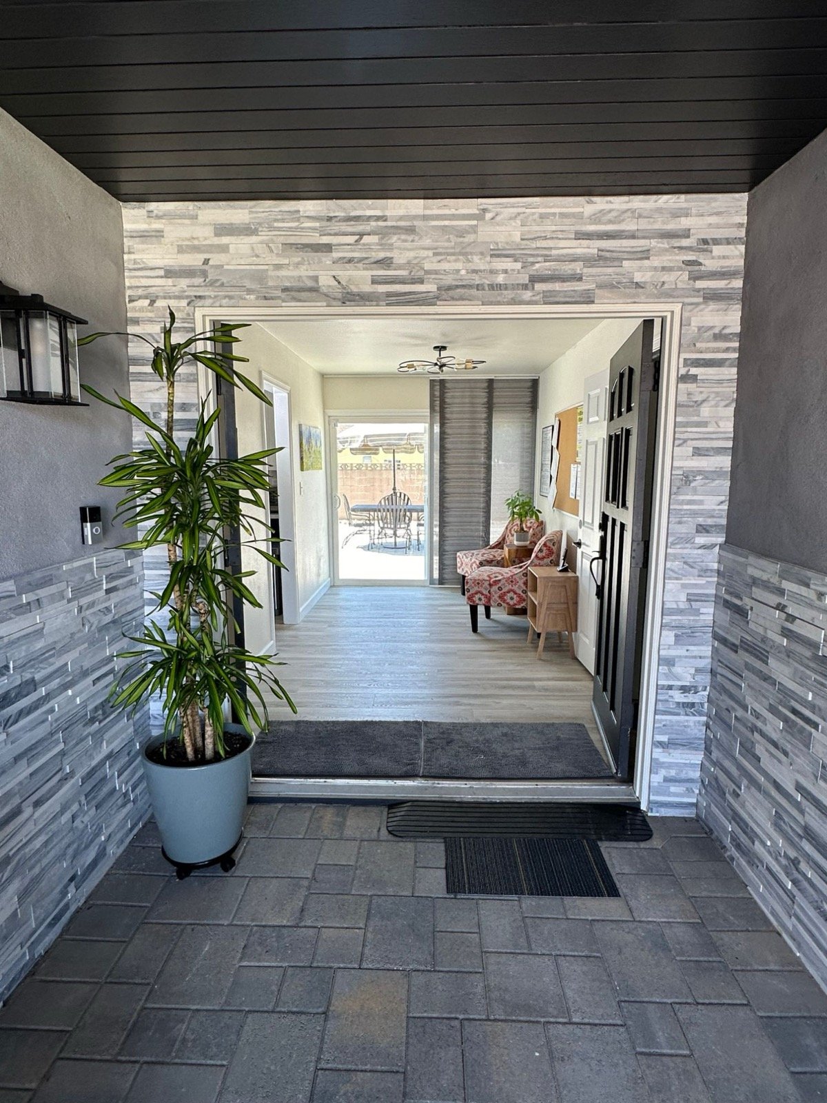 Covered front entry opening into the bright hallway